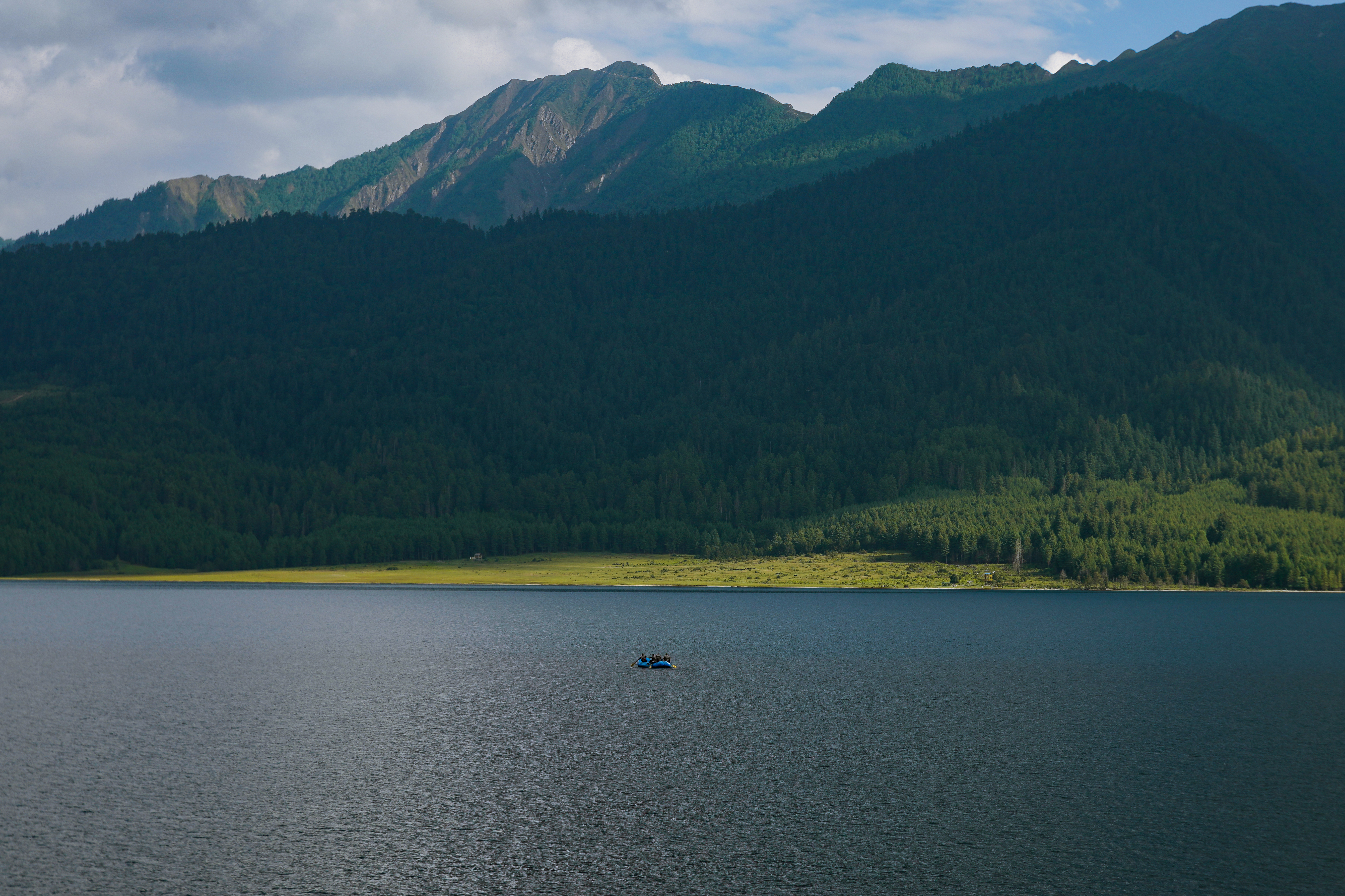 Rara Lake, remote Nepal — mountains, hills, and a single boat on the water